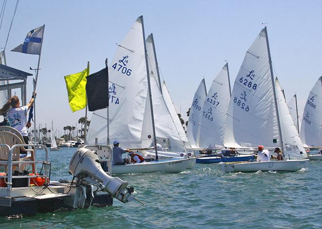 Committee boat (left) signals  a boat (r) for premature start © Rich Roberts